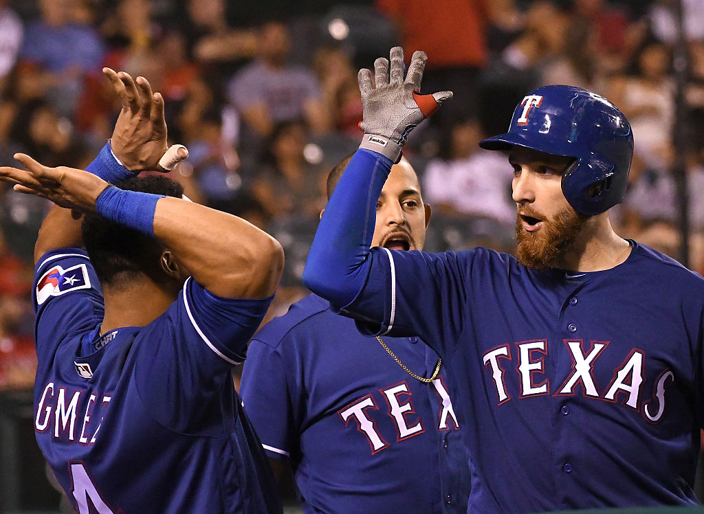 ANAHEIM, CA - SEPTEMBER 10:  Jonathan Lucroy #25 of the Texas Rangers gets high fives from Rougned Odor #12 and Carlos Gomez #14 after a 2 run home run in the eighth inning of the game against the Los Angeles Angels at Angel Stadium of Anaheim on September 10, 2016 in Anaheim, California. (Photo by Jayne Kamin-Oncea/Getty Images)