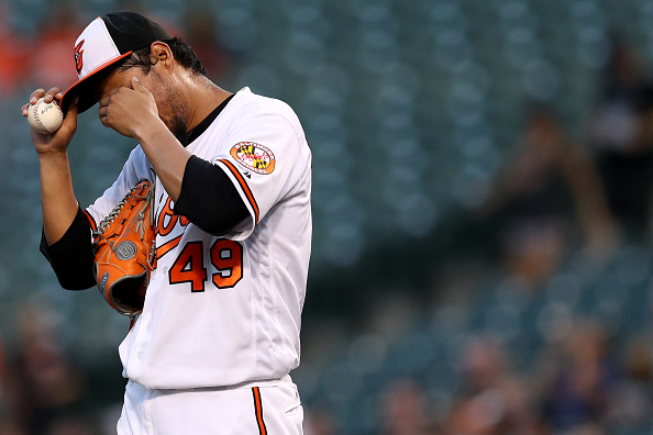 BALTIMORE, MD - AUGUST 31: Staring pitcher Yovani Gallardo #49 of the Baltimore Orioles reacts in the first inning against the Toronto Blue Jays at Oriole Park at Camden Yards on August 31, 2016 in Baltimore, Maryland. (Photo by Patrick Smith/Getty Images)